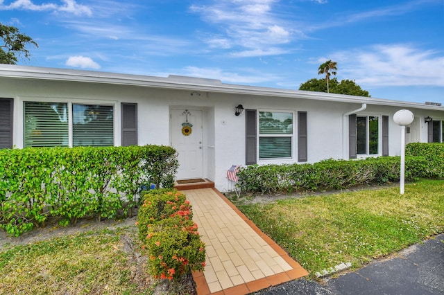 5154 Privet Pl Unit A, Delray Beach, FL 33484 - view of front of home with stucco siding and a front lawn