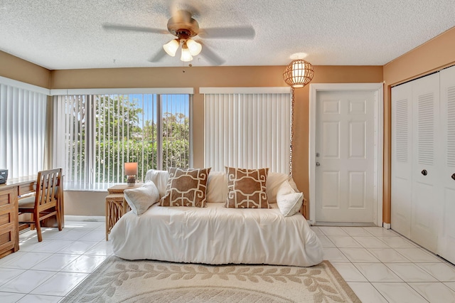 5154 Privet Pl Unit A, Delray Beach, FL 33484 - bedroom featuring light tile patterned floors, a textured ceiling, a closet, and a ceiling fan