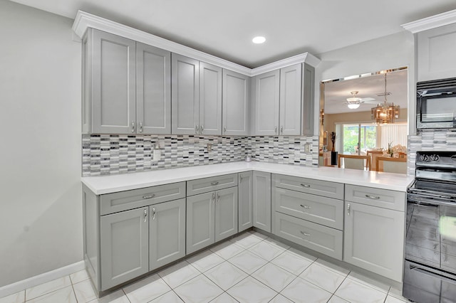 5154 Privet Pl Unit A, Delray Beach, FL 33484 - kitchen featuring gray cabinets, black appliances, backsplash, and recessed lighting
