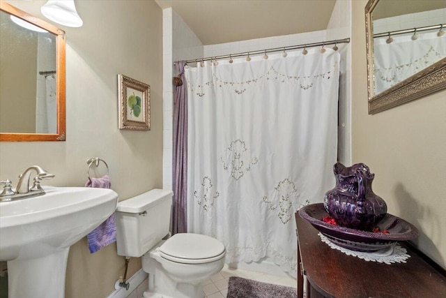 bathroom with tile patterned flooring, a sink, a shower with shower curtain, and toilet
