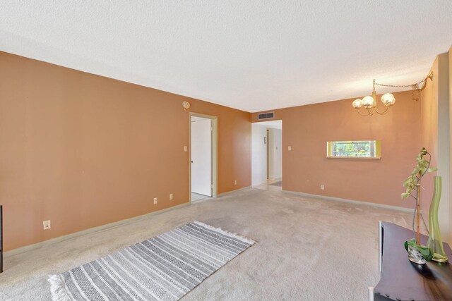 3301 NW 47th Ter Unit 410, Lauderdale Lakes, FL 33319 - unfurnished living room with baseboards, carpet flooring, a chandelier, and visible vents