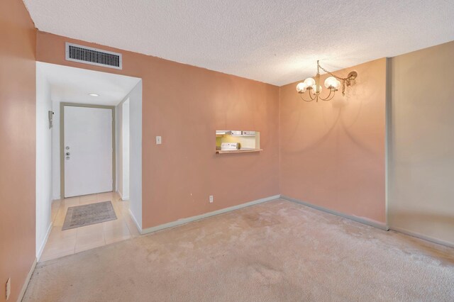 3301 NW 47th Ter Unit 410, Lauderdale Lakes, FL 33319 - carpeted empty room with a textured ceiling, a notable chandelier, baseboards, and visible vents