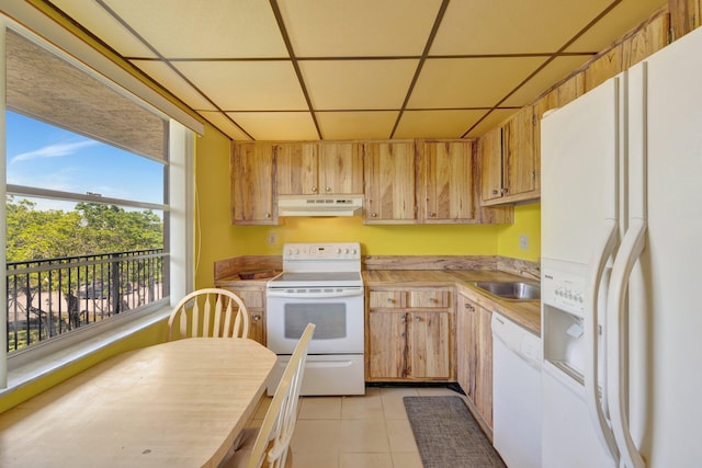 3301 NW 47th Ter Unit 410, Lauderdale Lakes, FL 33319 - kitchen featuring a drop ceiling, under cabinet range hood, white appliances, light tile patterned flooring, and a sink