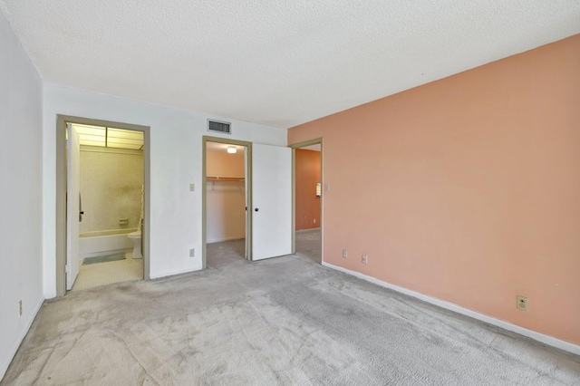 3301 NW 47th Ter Unit 410, Lauderdale Lakes, FL 33319 - unfurnished bedroom with ensuite bath, carpet, baseboards, and visible vents