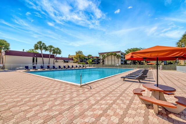 3301 NW 47th Ter Unit 410, Lauderdale Lakes, FL 33319 - community pool featuring a patio and fence