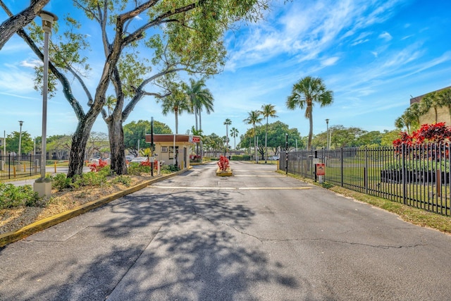 3301 NW 47th Ter Unit 410, Lauderdale Lakes, FL 33319 - view of road featuring street lights, a gated entry, and a gate