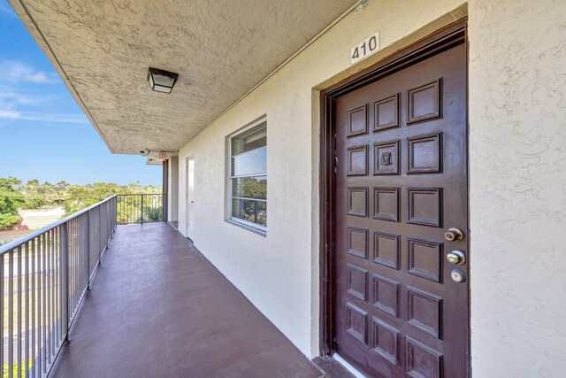 3301 NW 47th Ter Unit 410, Lauderdale Lakes, FL 33319 - property entrance with stucco siding and a balcony