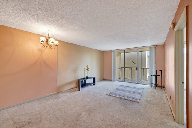 3301 NW 47th Ter Unit 410, Lauderdale Lakes, FL 33319 - interior space with a notable chandelier, a textured ceiling, and carpet floors