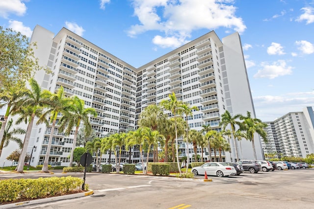 view of building exterior with uncovered parking