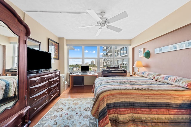 bedroom with ceiling fan and wood finished floors