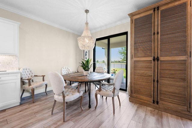 dining area featuring an inviting chandelier, baseboards, crown molding, and light wood-style flooring