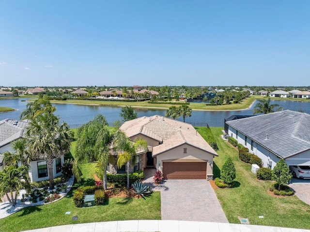 drone / aerial view featuring a residential view and a water view