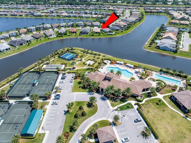 bird's eye view featuring a water view and a residential view