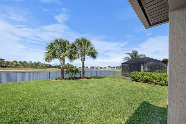 view of yard with a water view and a fenced backyard