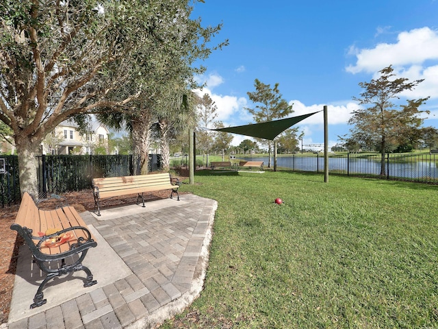 view of yard with a patio, a water view, and a fenced backyard