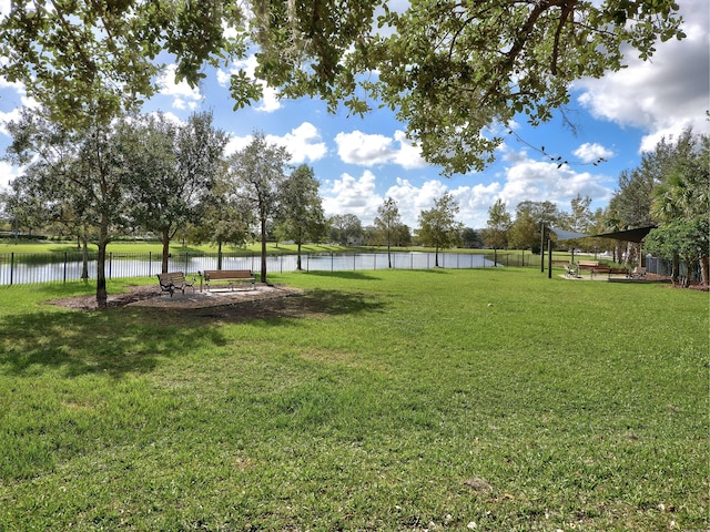 view of yard featuring fence and a water view