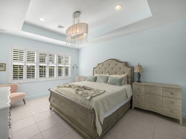 bedroom featuring visible vents, a raised ceiling, and light tile patterned floors