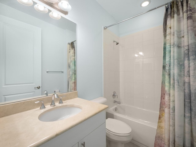 bathroom featuring shower / bath combo with shower curtain, toilet, and vanity