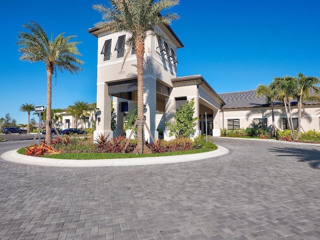 view of building exterior with curved driveway