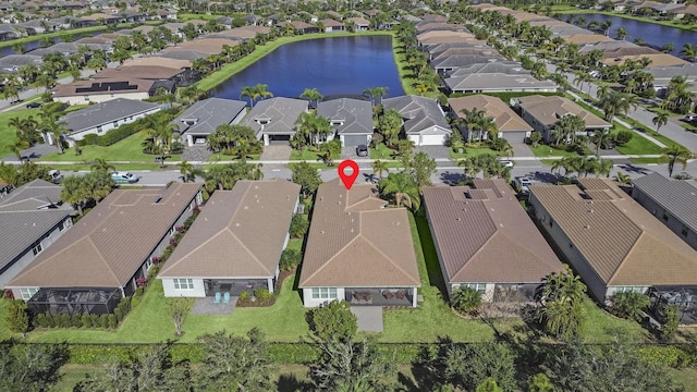 drone / aerial view with a water view and a residential view