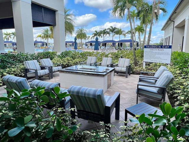 view of patio featuring an outdoor living space with a fire pit