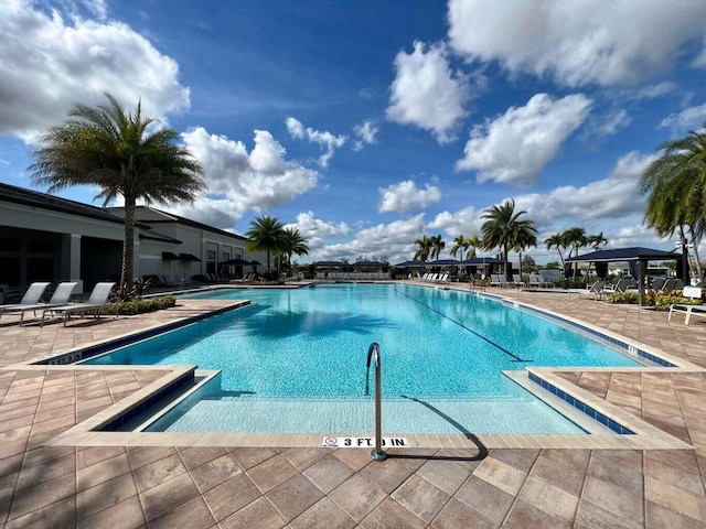 community pool with a patio area