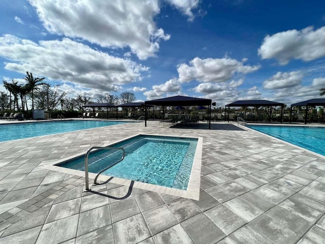pool with a patio and a gazebo