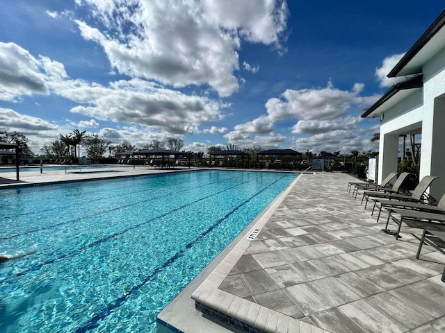community pool with a patio area