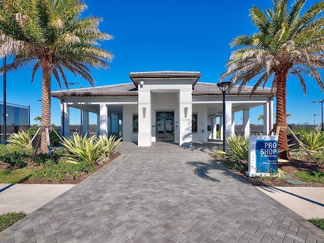 view of front facade with french doors and stucco siding