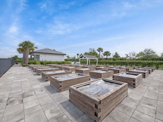view of patio / terrace with a gazebo and a vegetable garden