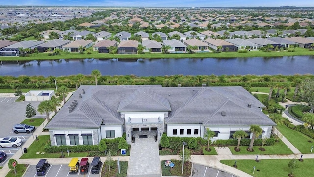 drone / aerial view featuring a water view and a residential view