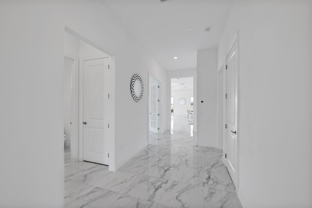 hall with recessed lighting, baseboards, and marble finish floor
