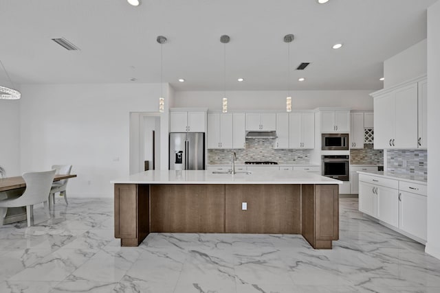 kitchen featuring under cabinet range hood, stainless steel appliances, visible vents, and marble finish floor