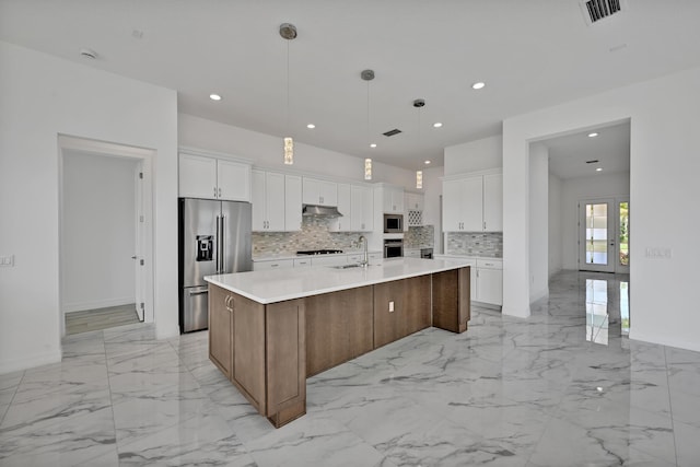 kitchen with visible vents, marble finish floor, appliances with stainless steel finishes, and tasteful backsplash
