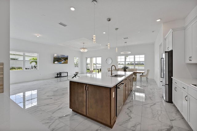 kitchen featuring a sink, light countertops, marble finish floor, stainless steel appliances, and recessed lighting