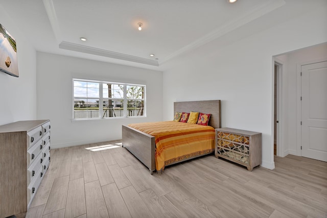 bedroom featuring recessed lighting, a raised ceiling, baseboards, and light wood finished floors