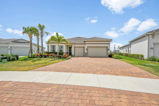 view of front facade featuring an attached garage, a front lawn, stucco siding, decorative driveway, and a tiled roof
