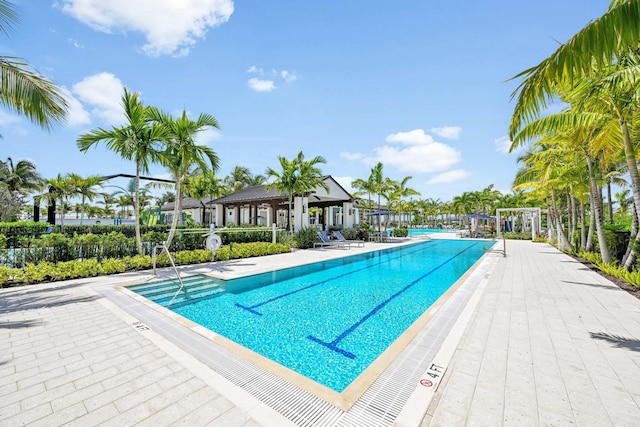 pool with fence and a patio