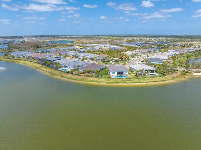 drone / aerial view with a residential view and a water view