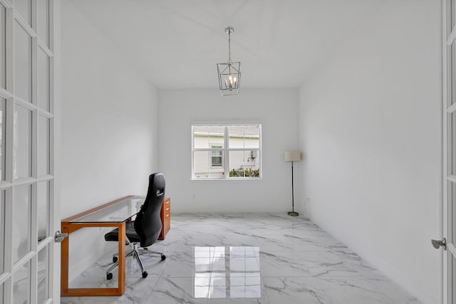 home office featuring an inviting chandelier and marble finish floor