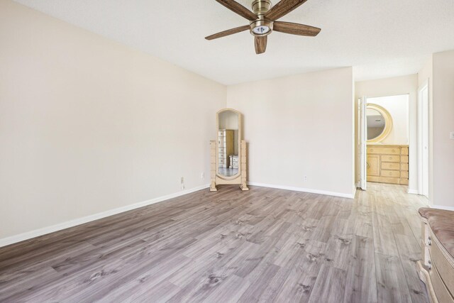 5748 Fox Hollow Dr Unit D, Boca Raton, FL 33486 - empty room featuring a ceiling fan, baseboards, and light wood finished floors