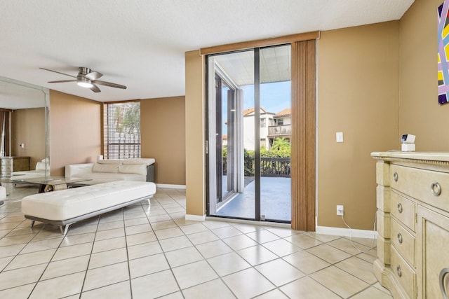 5748 Fox Hollow Dr Unit D, Boca Raton, FL 33486 - living room with light tile patterned floors, baseboards, and ceiling fan