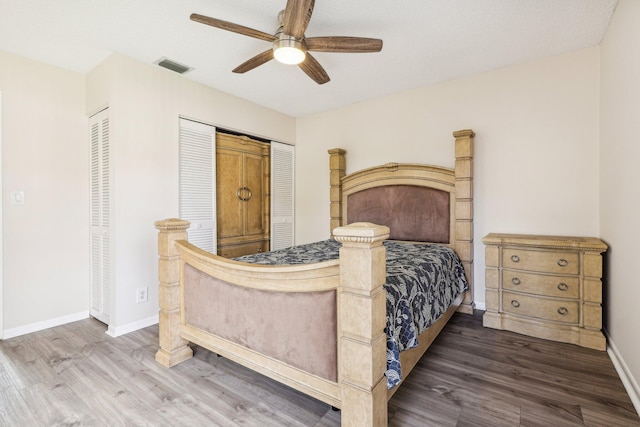 5748 Fox Hollow Dr Unit D, Boca Raton, FL 33486 - bedroom featuring ceiling fan, two closets, baseboards, wood finished floors, and visible vents