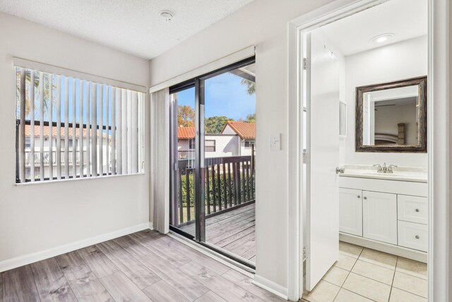 5748 Fox Hollow Dr Unit D, Boca Raton, FL 33486 - doorway featuring baseboards and a sink