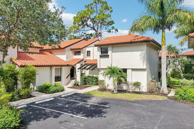 5748 Fox Hollow Dr Unit D, Boca Raton, FL 33486 - mediterranean / spanish-style house with uncovered parking, stucco siding, and a tiled roof