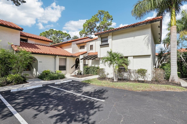 5748 Fox Hollow Dr Unit D, Boca Raton, FL 33486 - view of front of property featuring uncovered parking, a tile roof, and stucco siding