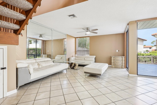 5748 Fox Hollow Dr Unit D, Boca Raton, FL 33486 - living room with a ceiling fan, baseboards, light tile patterned floors, visible vents, and expansive windows