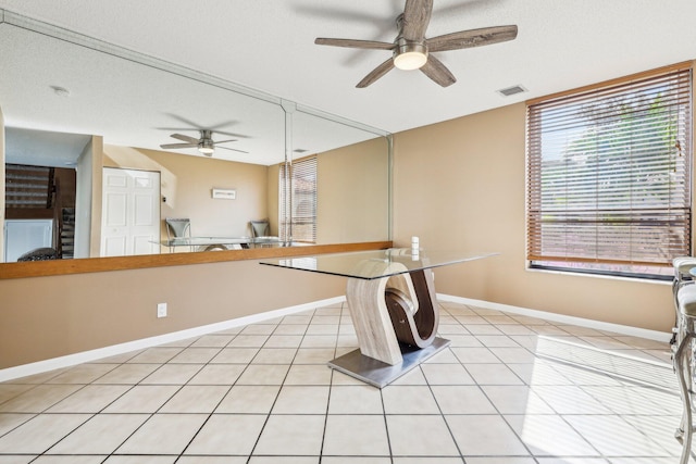 5748 Fox Hollow Dr Unit D, Boca Raton, FL 33486 - unfurnished dining area featuring visible vents, baseboards, ceiling fan, and light tile patterned floors