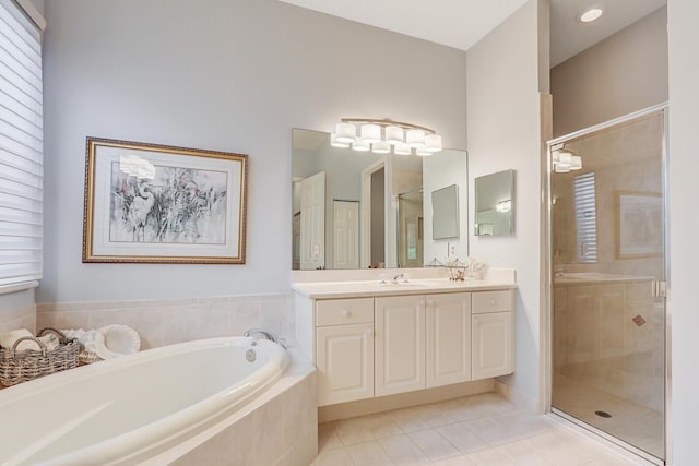 full bath featuring tile patterned floors, a garden tub, vanity, and a shower stall