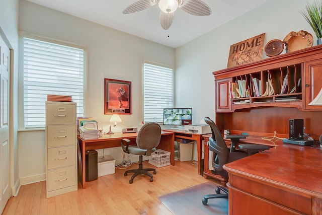office area with a ceiling fan, a wealth of natural light, and light wood-style flooring